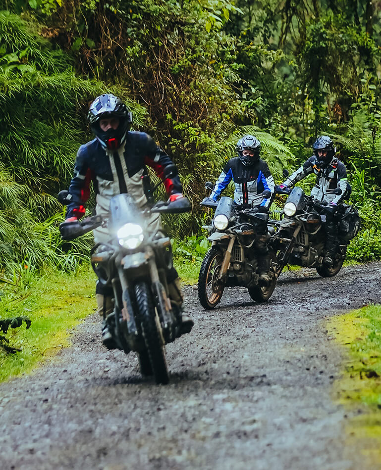 Group of motorcycle riders in RE Himalayans 450 driving through an off-road route in Colombia during a tour with Fire of The South